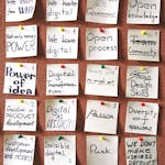 A staircase made of sticky notes leading upward, each labeled with a tiny goal or task.