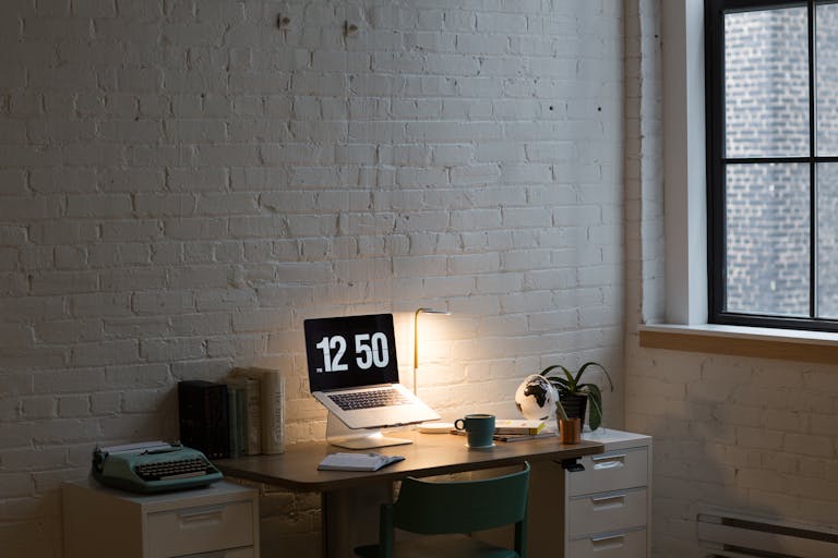 A well-organized desk with a planner, clock, and coffee cup, symbolizing efficient time management.
