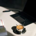 A sunrise with coffee, planner, and laptop on a tidy desk.