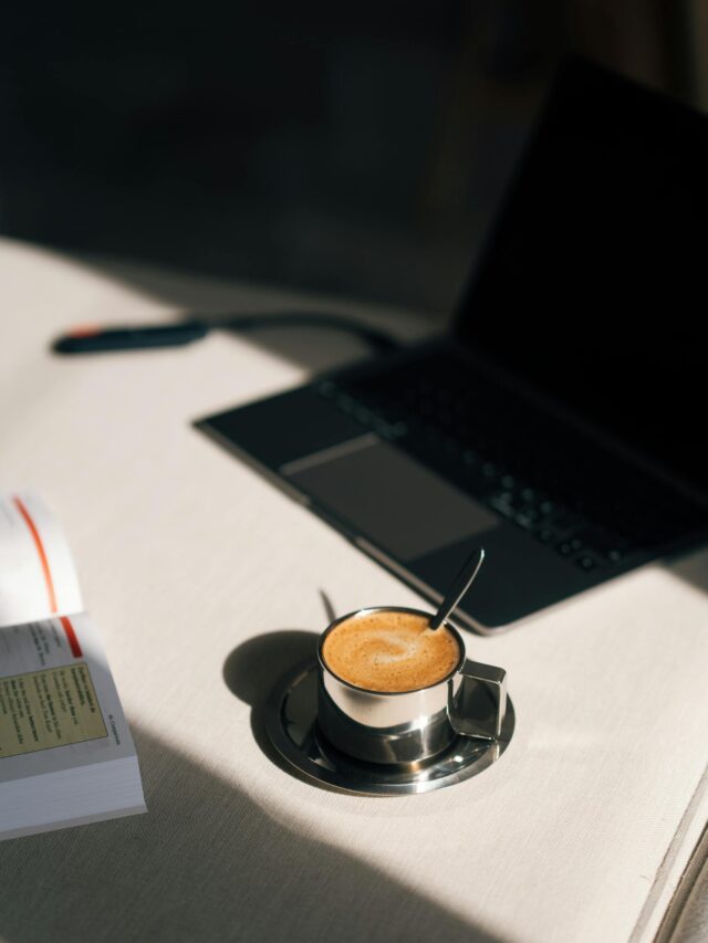 A sunrise with coffee, planner, and laptop on a tidy desk.