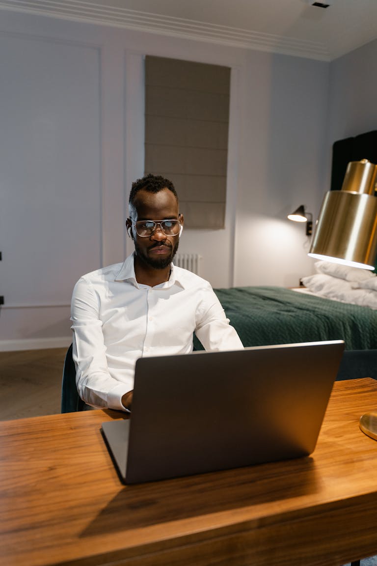 A person working from home at a desk, surrounded by a tidy, organized workspace