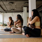 A calm person meditating in the middle of a chaotic or busy environment