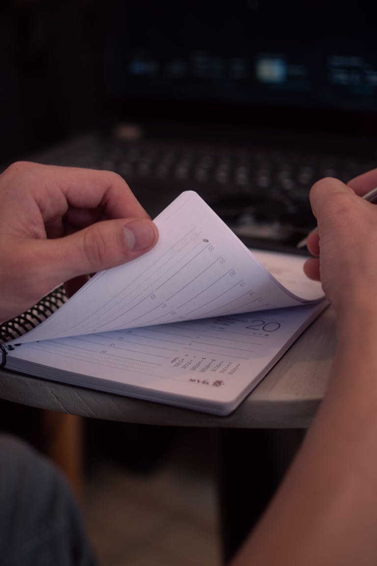 A person planning their day on a calendar or using a time management tool