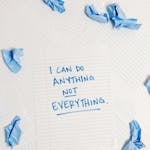 Inspirational message on a notepad surrounded by crumpled paper pieces.