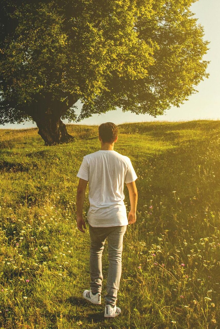 A person enjoying a peaceful morning hike with no phone in sight.