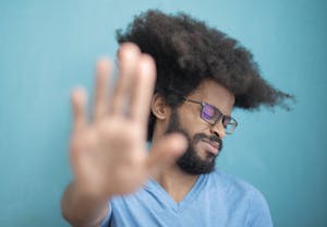 A hand stopping an overflowing inbox or a crossroads with a "Yes" and "No" signpost.