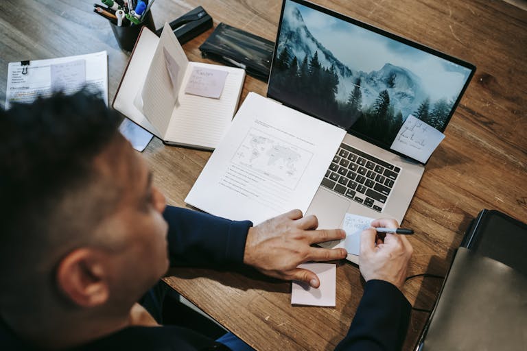 A person focused on one task with open notebooks and no devices around