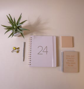 A calendar with checkmarks and motivational quotes, symbolizing habit tracking