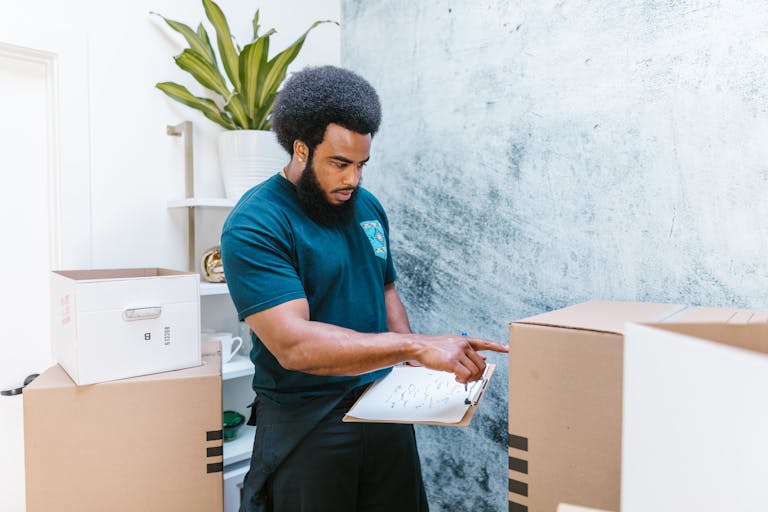 A person ticking off small tasks on a checklist with a timer nearby