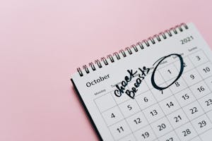 A close-up of a calendar with tiny checkmarks on each day symbolizing habit tracking.