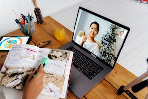 A person using a laptop or tablet, engaging with an educational app or online course.