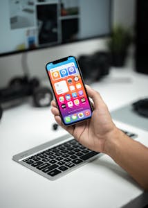 A minimalist smartphone screen with only essential apps, set on a clean desk.