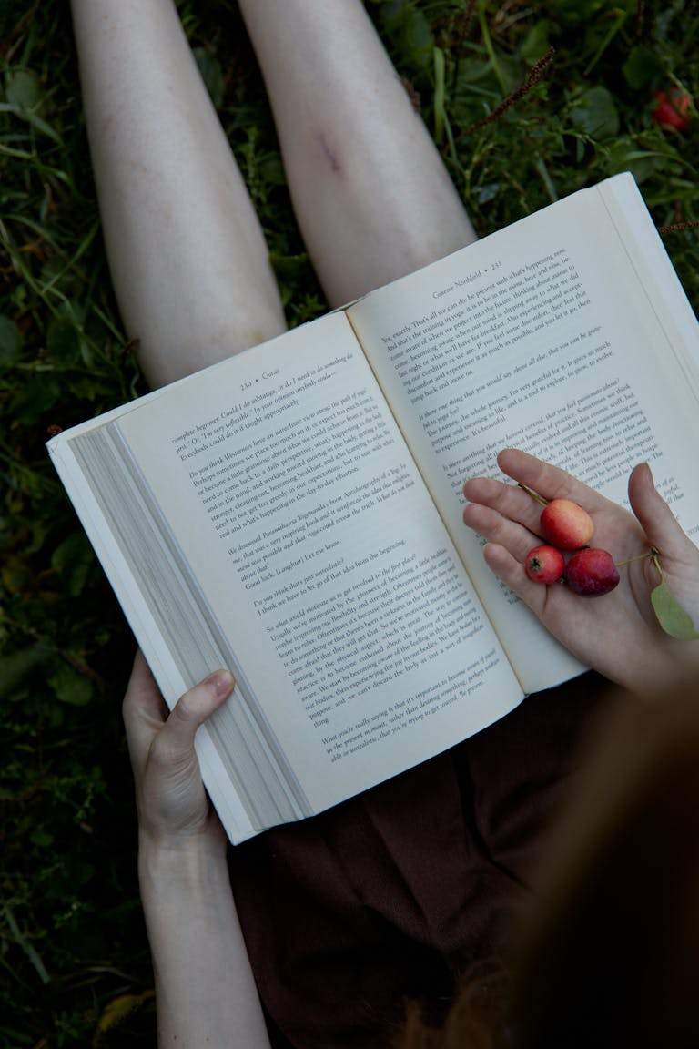A person relaxing in nature, reading a book, or engaging in mindful activities without digital devices