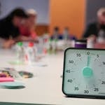 A person setting a 10-minute timer while preparing to work
