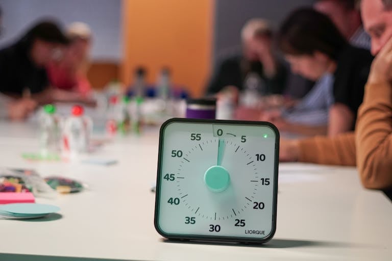 A person setting a 10-minute timer while preparing to work