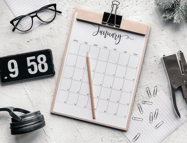 A person organizing their schedule on a digital calendar or planner with clear blocks of time.