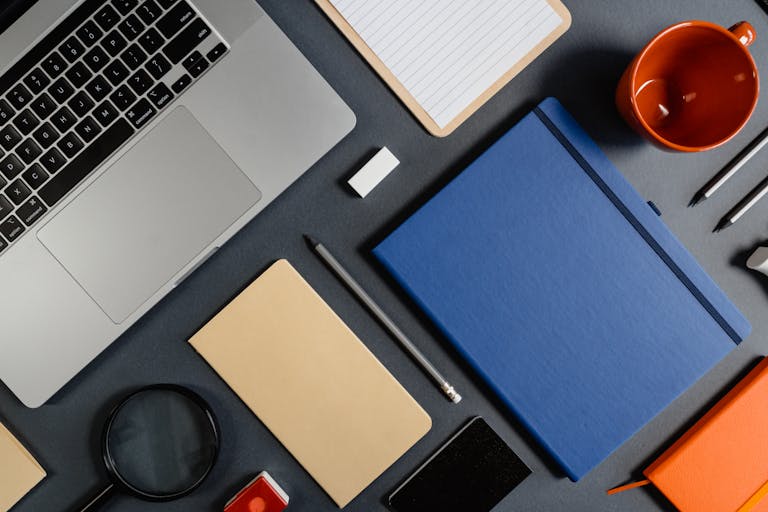 A neatly organized workspace with a calendar, clock, and productivity tools like a notebook and pen.