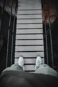 A person stepping forward on a cracked but solid path, leaving behind a glowing “perfect” sign