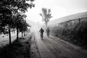 A person at a crossroads with one clear, confident path forward while other paths are foggy or tangled.
