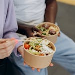A split-screen showing a person choosing between junk food and a salad.