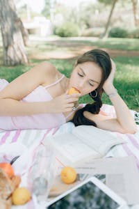 A person taking a break from their phone, enjoying nature or a book