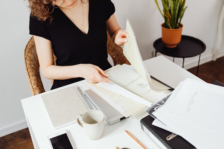 A person working intently at a minimalist desk, no phone or clutter in sight
