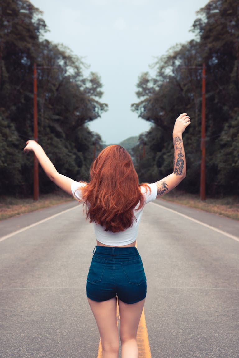 A determined person standing at the start of a long road with confidence