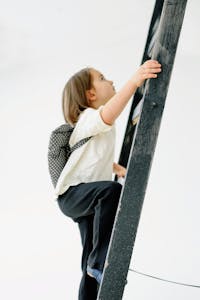 A person climbing a mountain, symbolizing overcoming obstacles, or a brain with gears turning, representing the development of a growth mindset.
