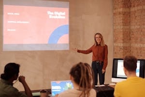A person confidently presenting in front of an audience or sharing a story on social media with a professional but approachable demeanor.