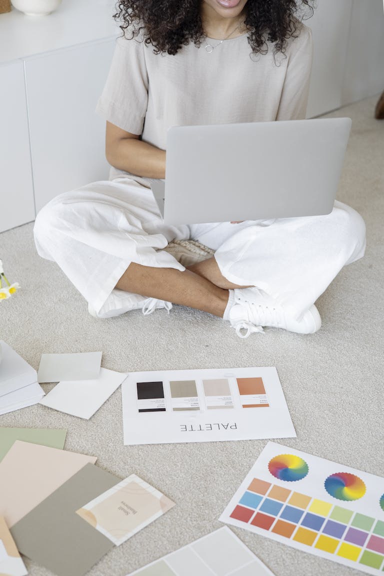 An entrepreneur confidently presenting themselves in front of a laptop, with their personal brand elements (logo, color palette) subtly integrated into their workspace.