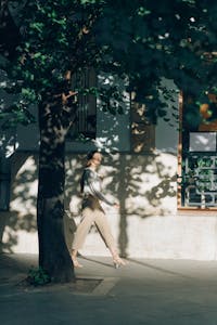 A person walking in nature with a phone turned off in their pocket, sunlight filtering through trees.